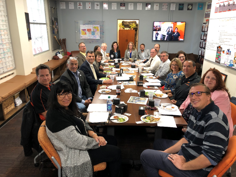 Partners gather around a table to talk about projects and initiatives