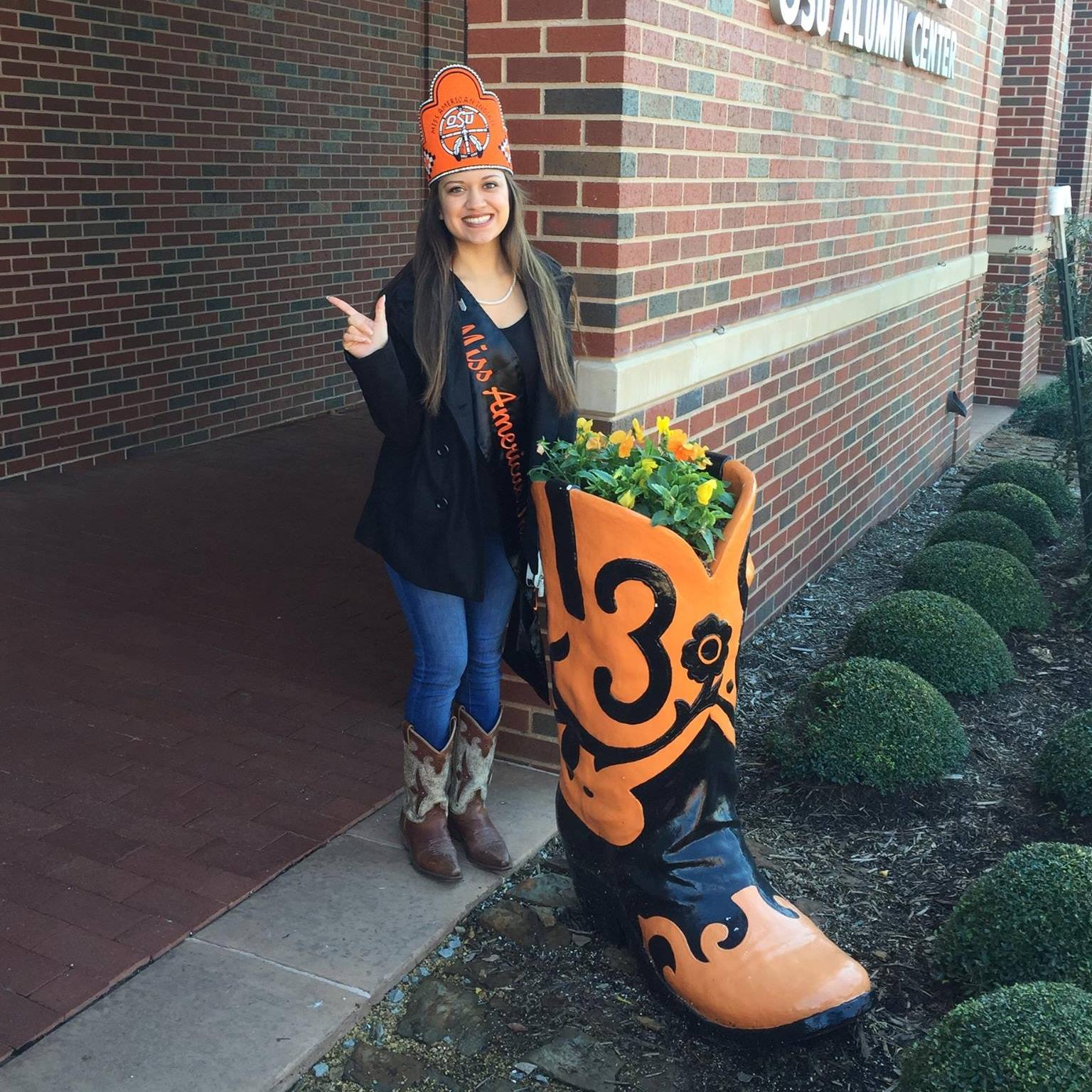 Miss American Indian OSU Pictured standing outside wearing sash and crown